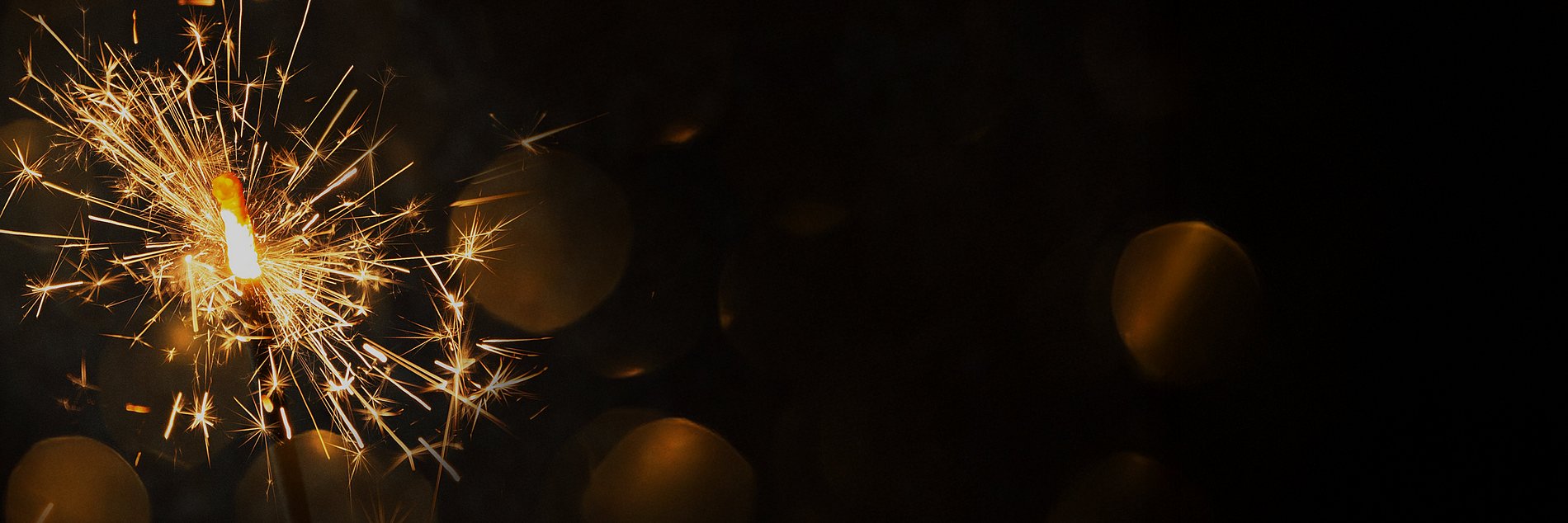 Eine brennende Wunderkerze im Dunkeln.