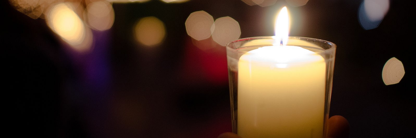 Kerze im Glas mit Hintergrund