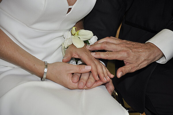 Das Brautpaar hält sich an den Händen.